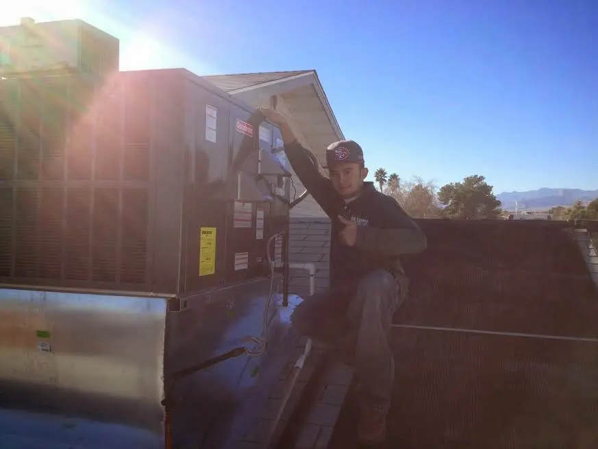 HVAC technician performing HVAC Inspection on a rooftop unit in Fort Belvoir